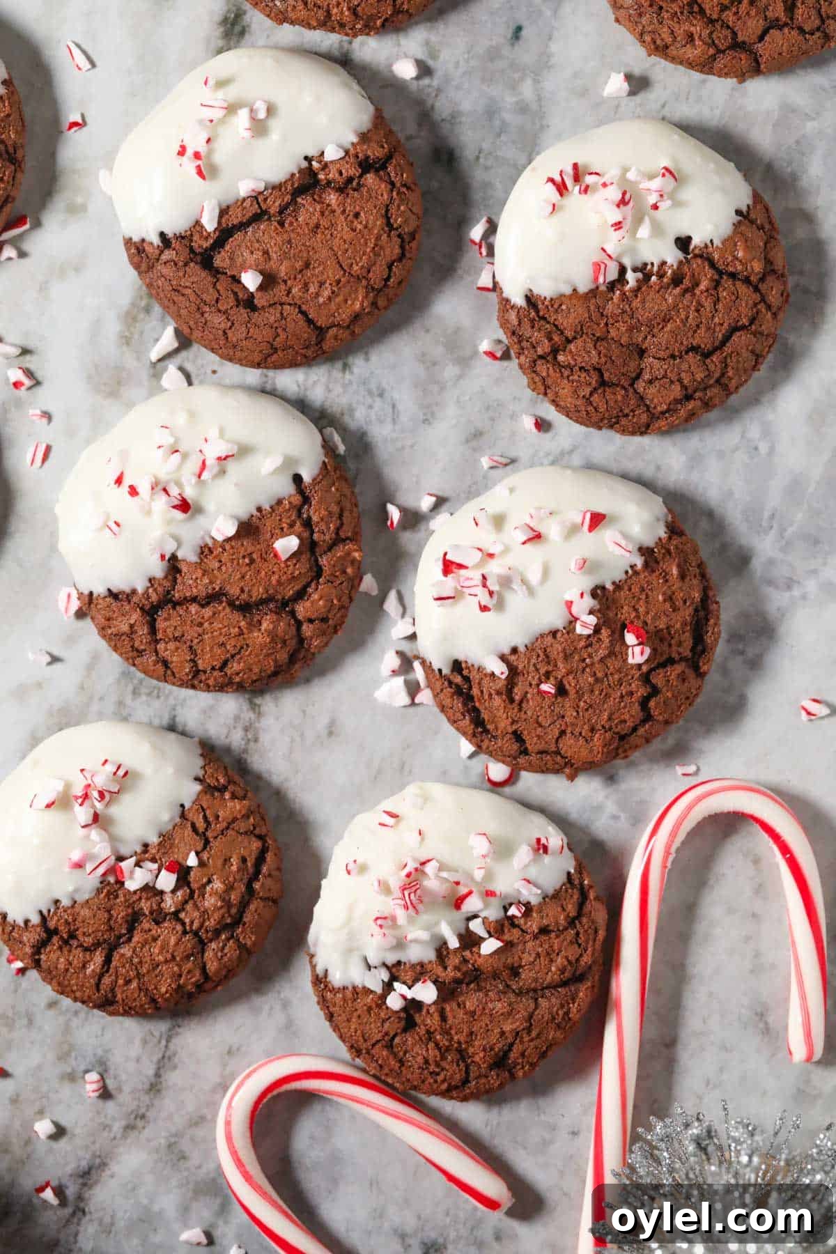 Peppermint bark brownie cookies arranged on a marble surface.