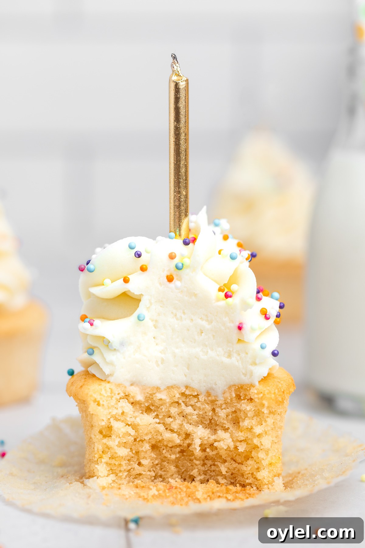 birthday cupcake cut in half showing a soft vanilla crumb inside