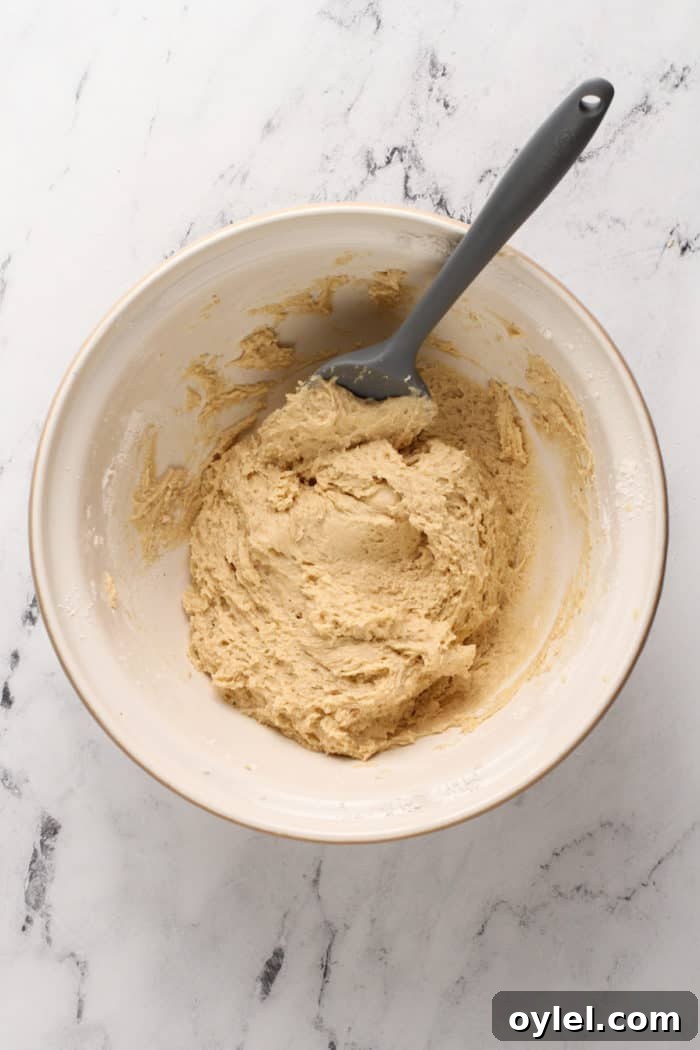 Dough for chocolate glazed donuts in a ceramic mixing bowl.