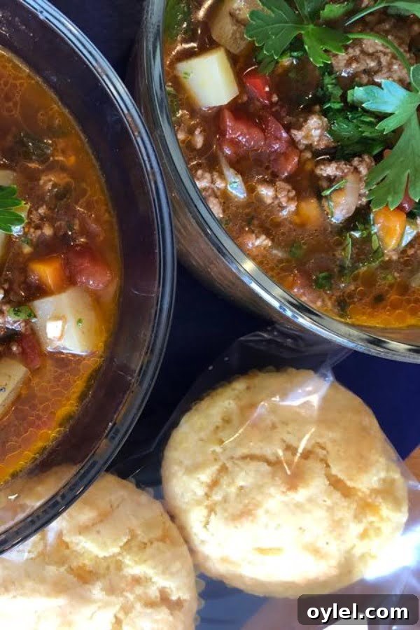 2 bowls of hamburger soup with cornbread muffins