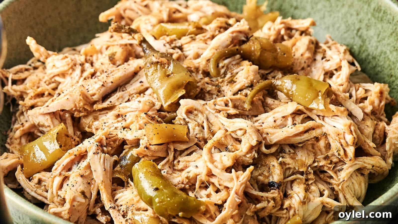 35 Chicken Breast Recipes to Simplify Weeknight Dinners 9 Shredded chicken mixed with sliced green peppers and seasoning in a green bowl.