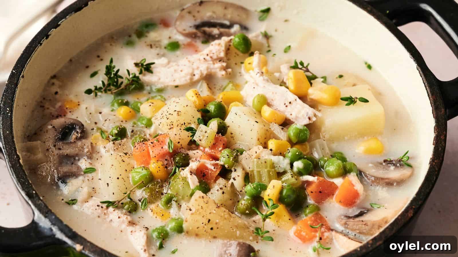 35 Chicken Breast Recipes to Simplify Weeknight Dinners 26 A pot of creamy vegetable and chicken soup with mushrooms, corn, peas, carrots, and herbs.