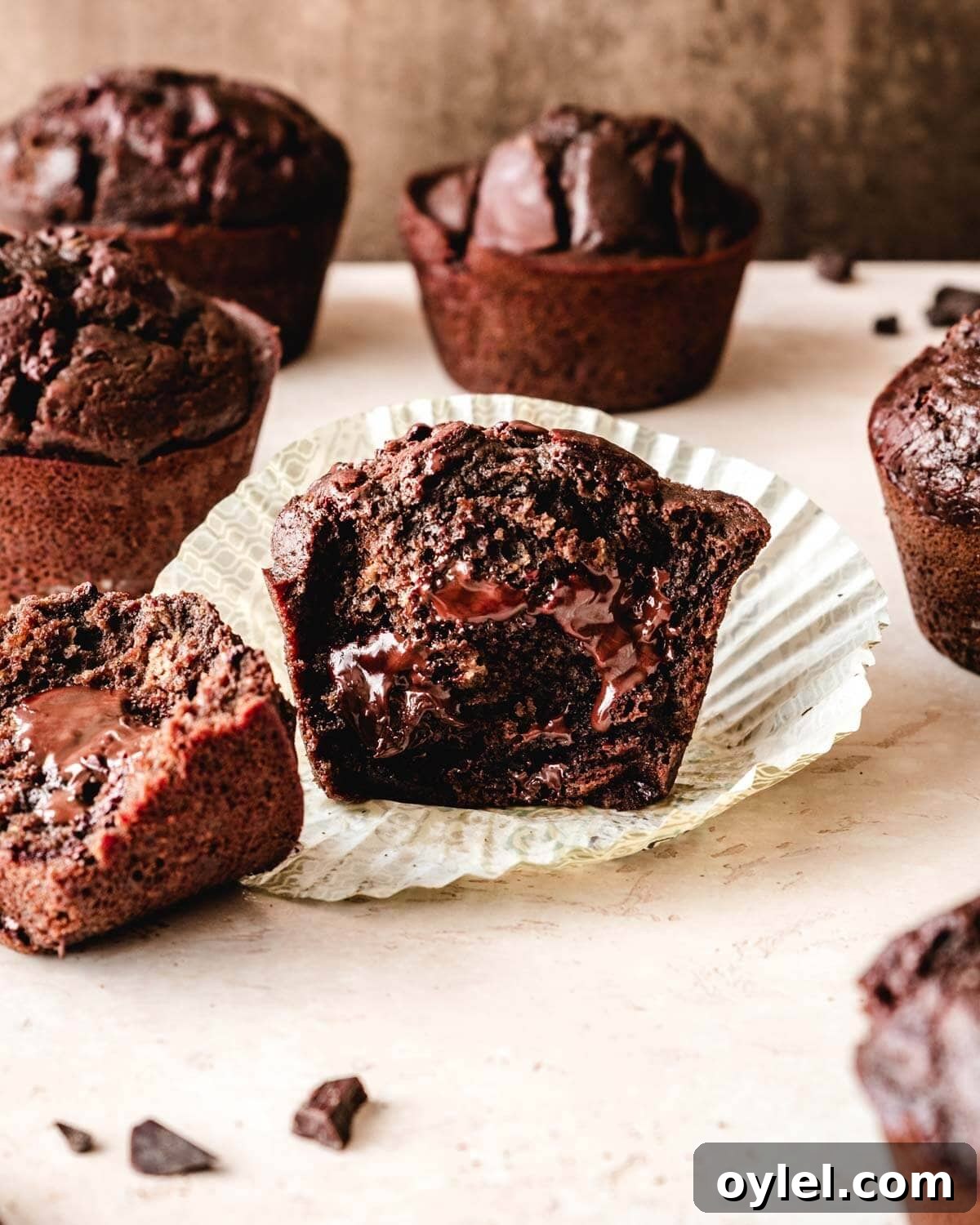 Bakery style chocolate chunk muffin split in half.