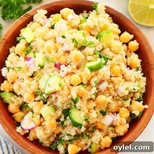 Salad with quinoa and chickpeas in a wooden bowl.
