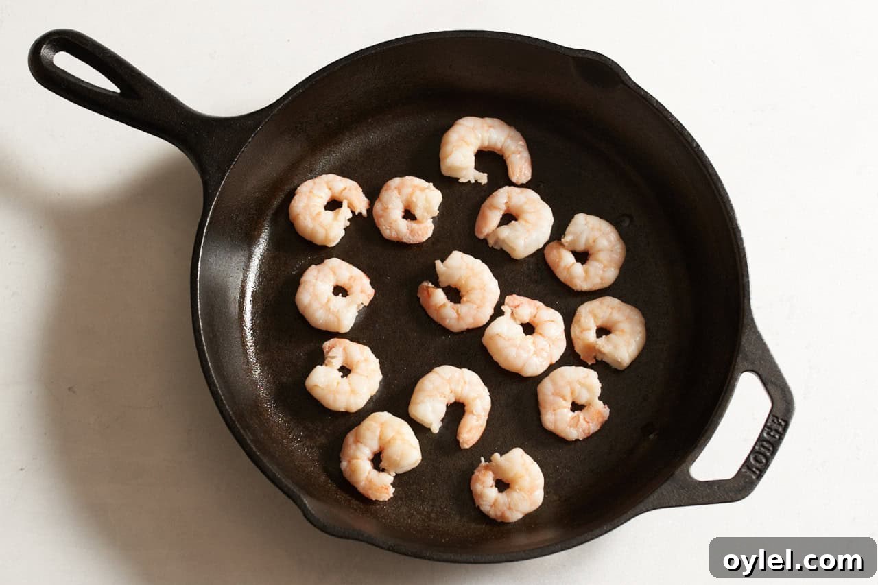 Crispy Mexican Shrimp Tostadas with Avocado Crema 6 Cooked shrimp in a cast iron skillet.