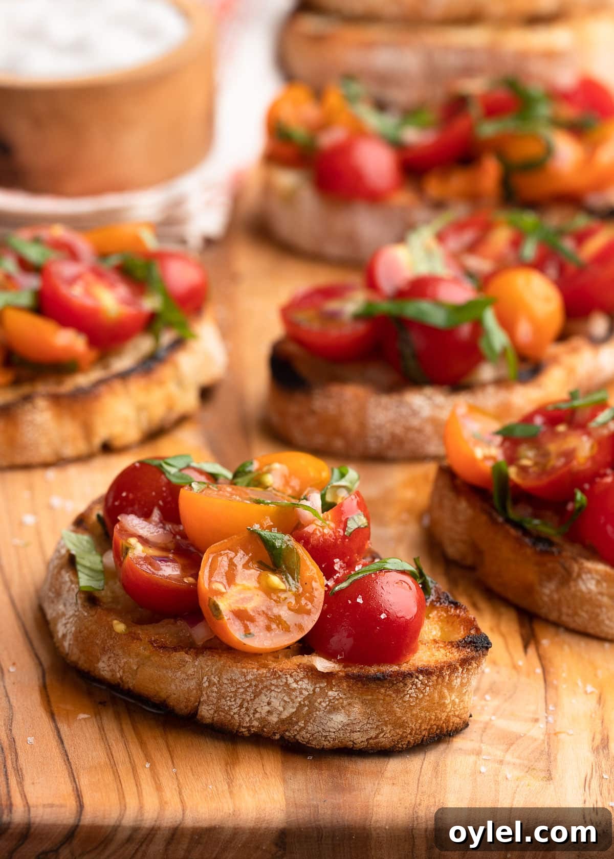 Cherry Tomato Bruschetta on an olivewood serving board.