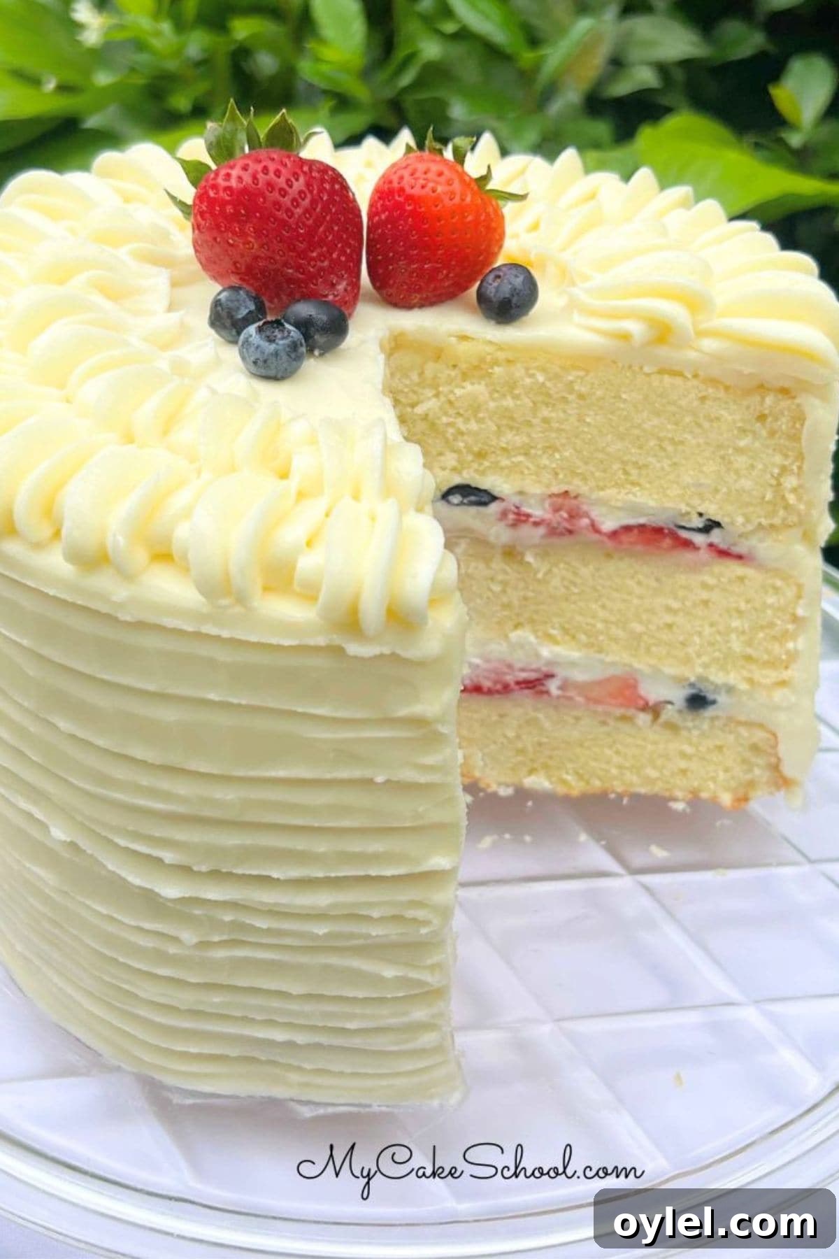 Berry Mascarpone Cake, sliced, on a cake pedestal.