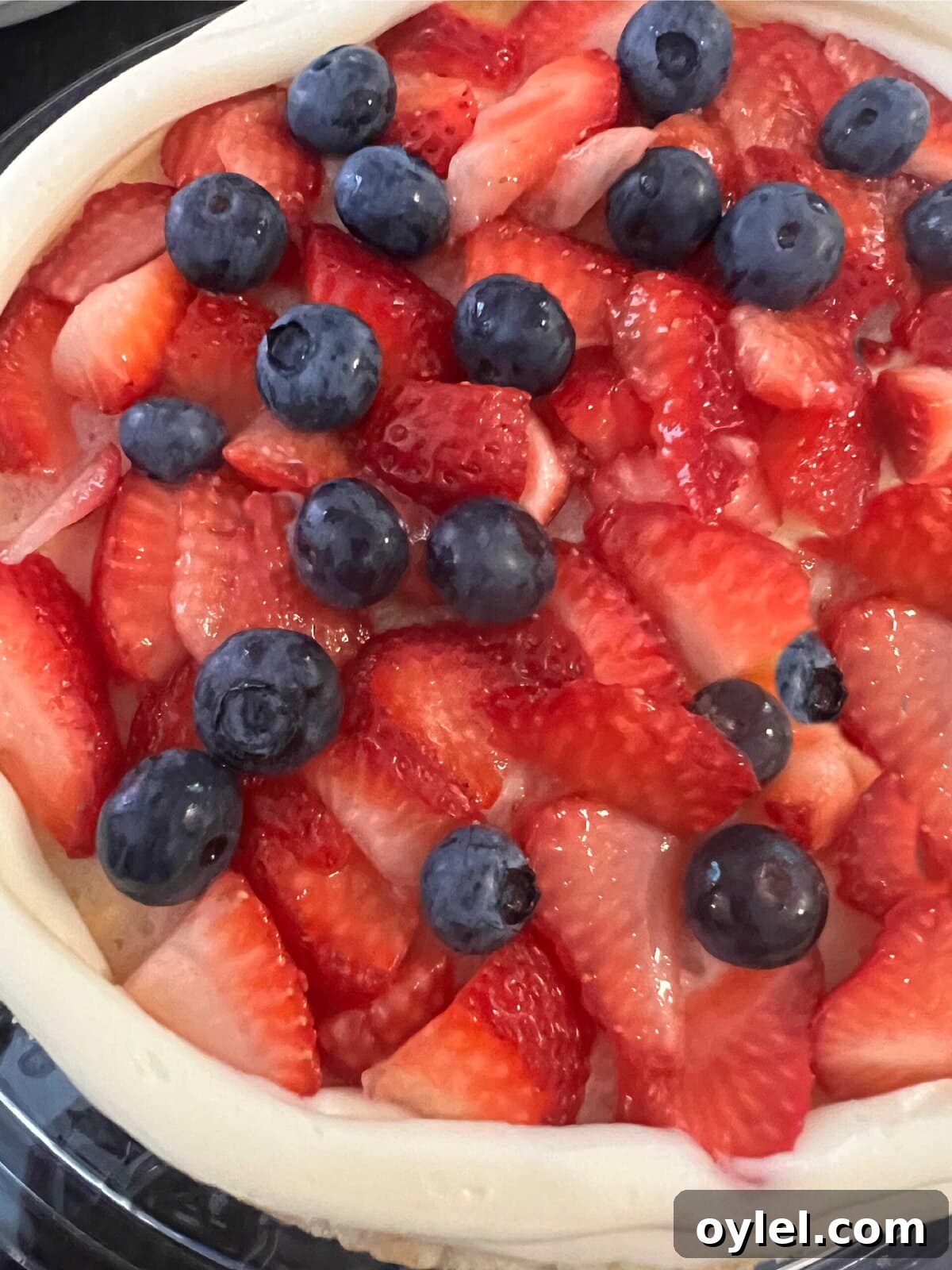 Berries on a vanilla mascarpone cake layer.
