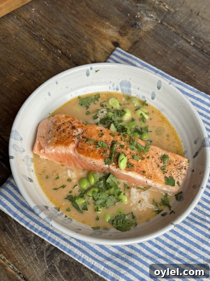 Coconut Curry Salmon in Creamy Fragrant Broth 11 a photo of salmon with coconut curry broth in a bowl