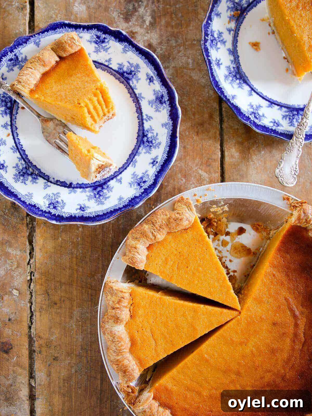 Classic Southern Sweet Potato Pie Recipe with Spiced Filling 2 Sweet Potato Pie sliced on blue plates.