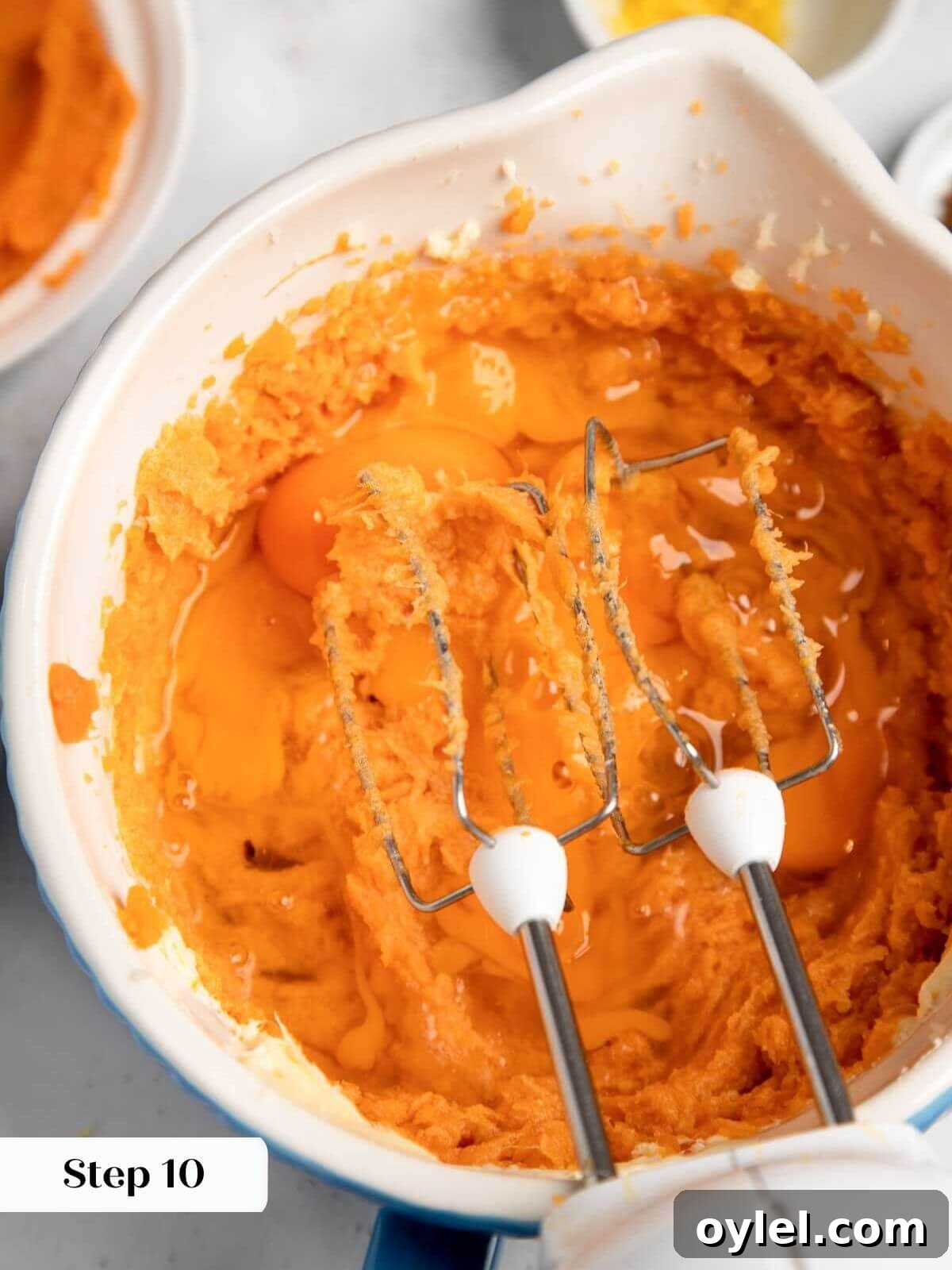 Classic Southern Sweet Potato Pie Recipe with Spiced Filling 7 beating eggs into sweet potato pie filling.