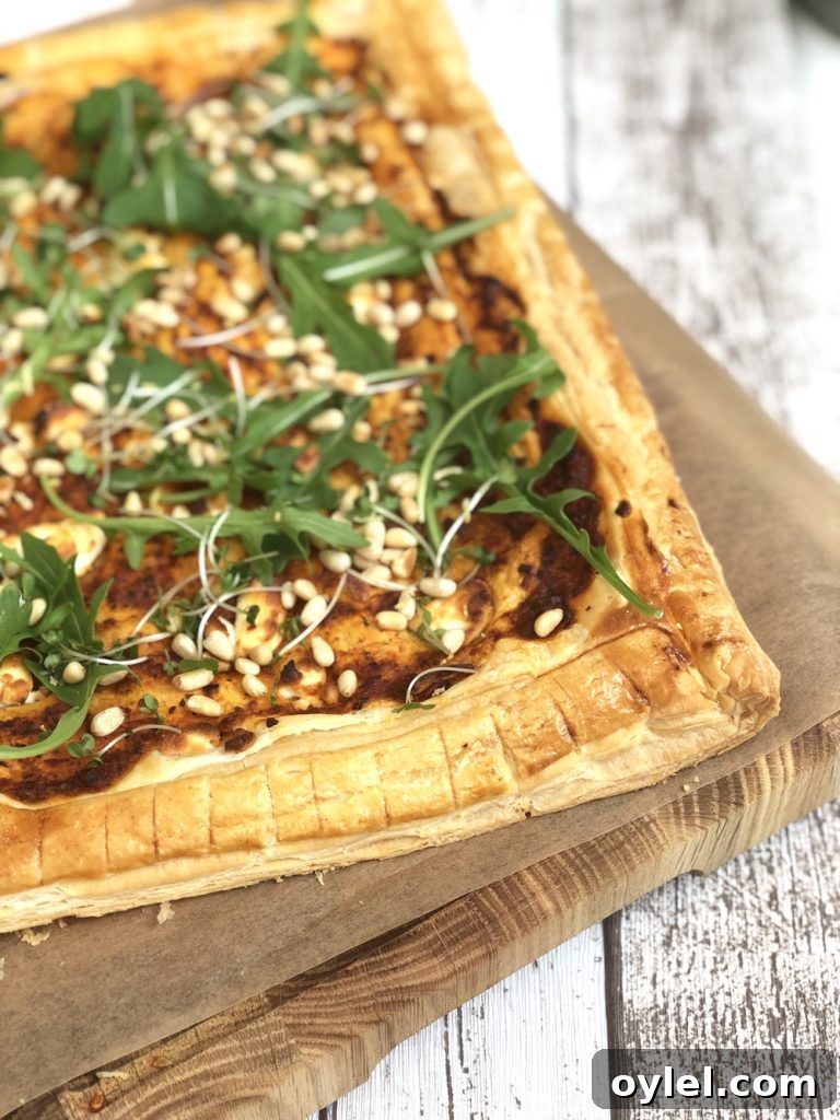 goat cheese tart with rocket and pine nuts.