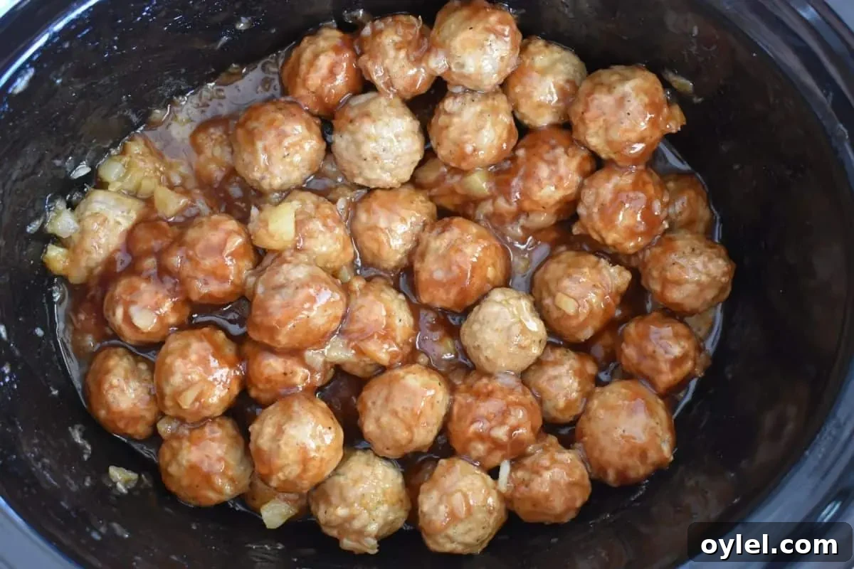 4-Ingredient Slow Cooker Hawaiian Meatballs 6 Slow cooker Hawaiian meatballs in a slow cooker after cooking for 4 hours.