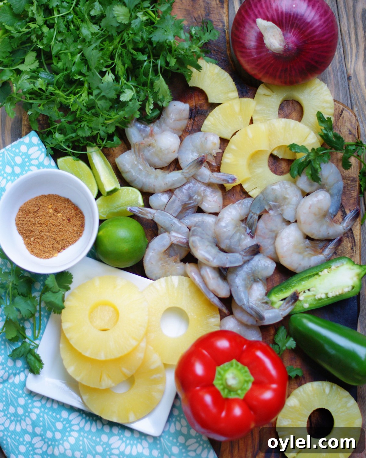 Sheet Pan Pineapple Shrimp Dinner with red bell peppers, onion, jalapenos, cilantro, lime and jerk seasoning.