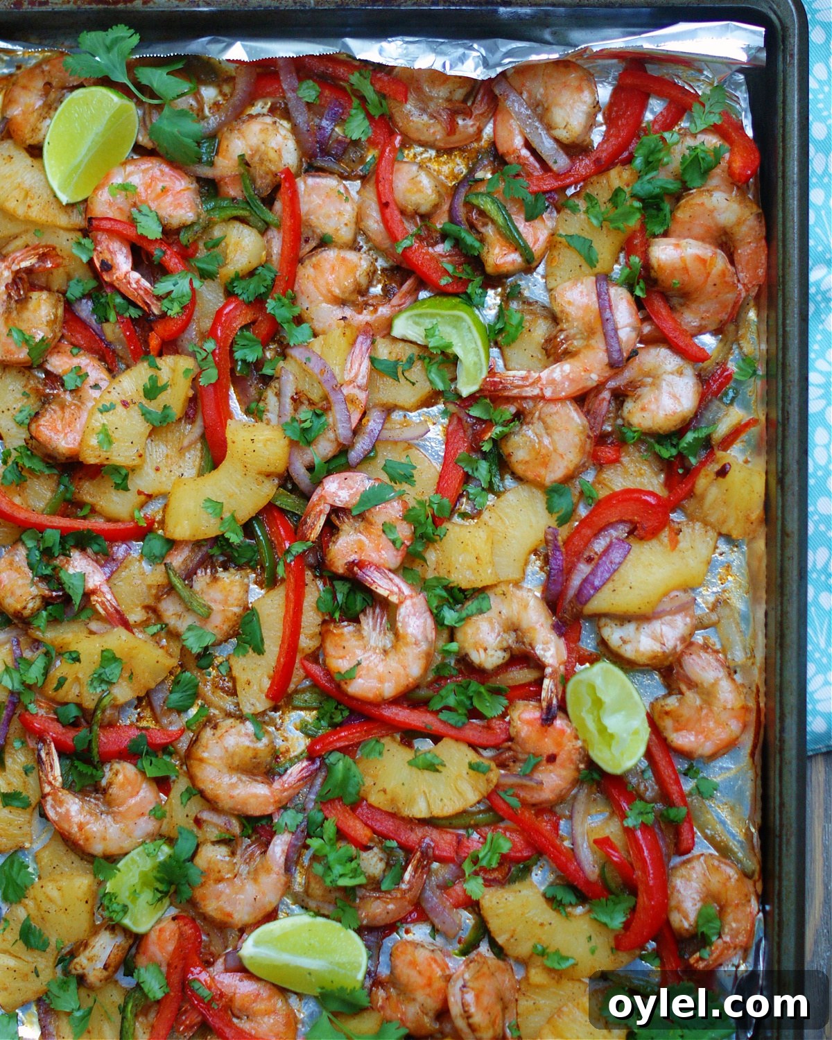 One pan meal with pineapple, shrimp, roasted vegetables and peppers save time.