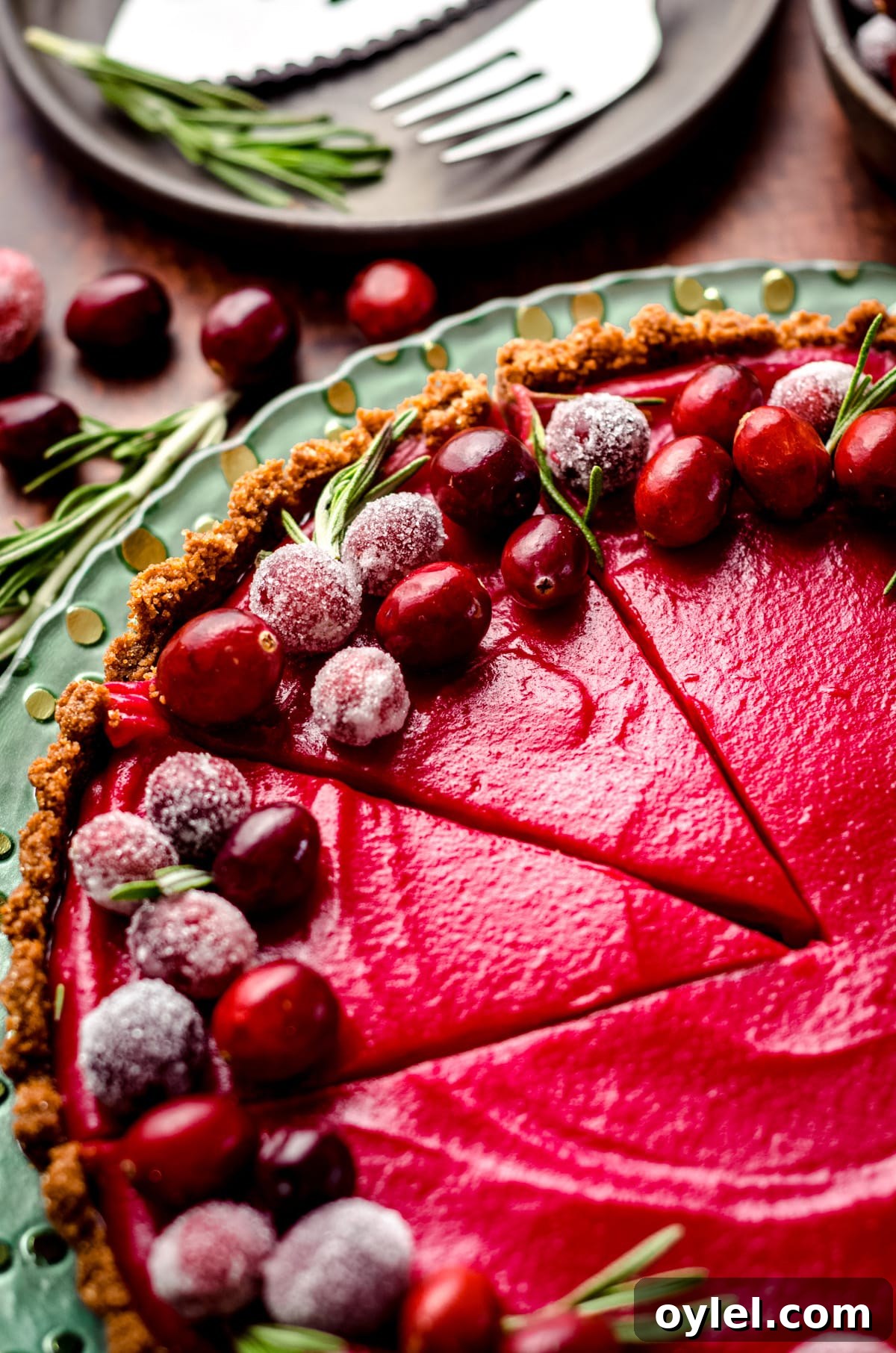 Silky Cranberry Curd Tart Recipe with Buttery Crust 2 sliced cranberry curt tart on a plate