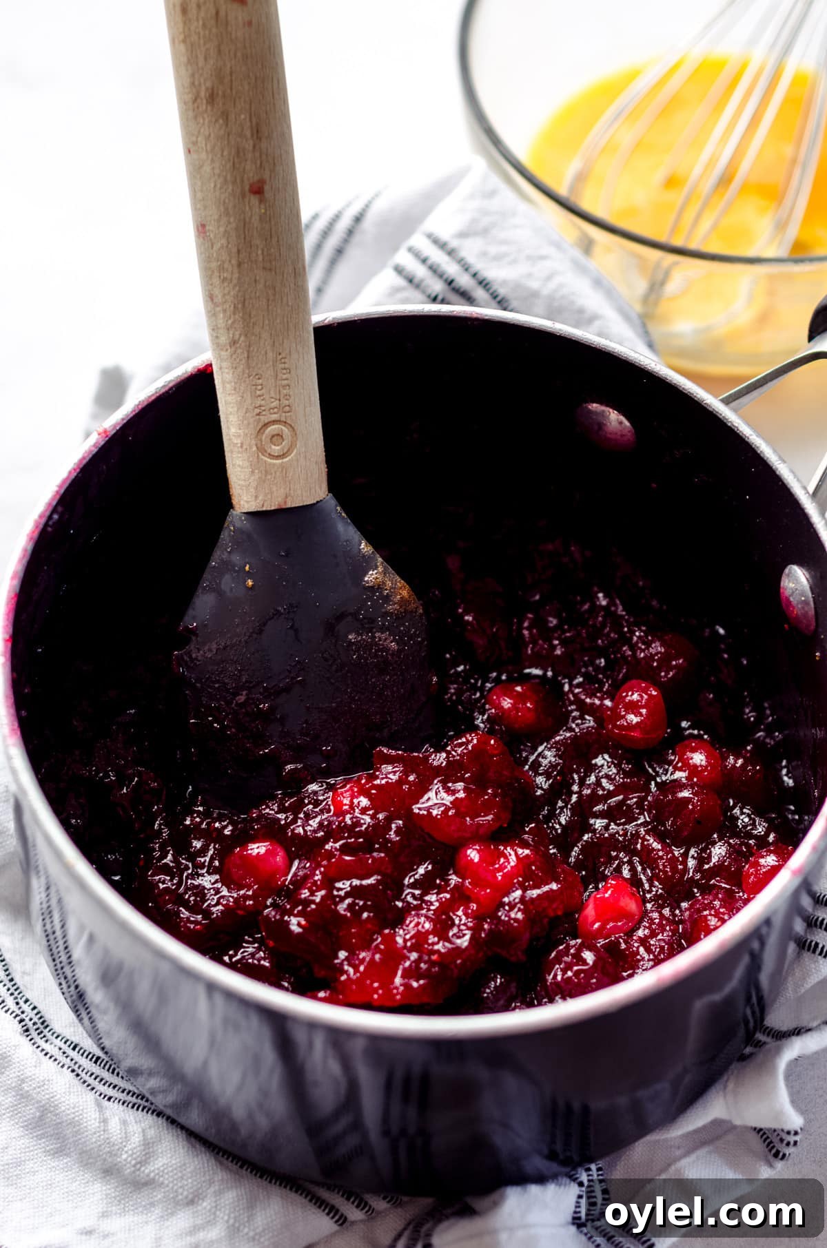 Silky Cranberry Curd Tart Recipe with Buttery Crust 6 macerated cranberries in a saucepan ready to make cranberry curd