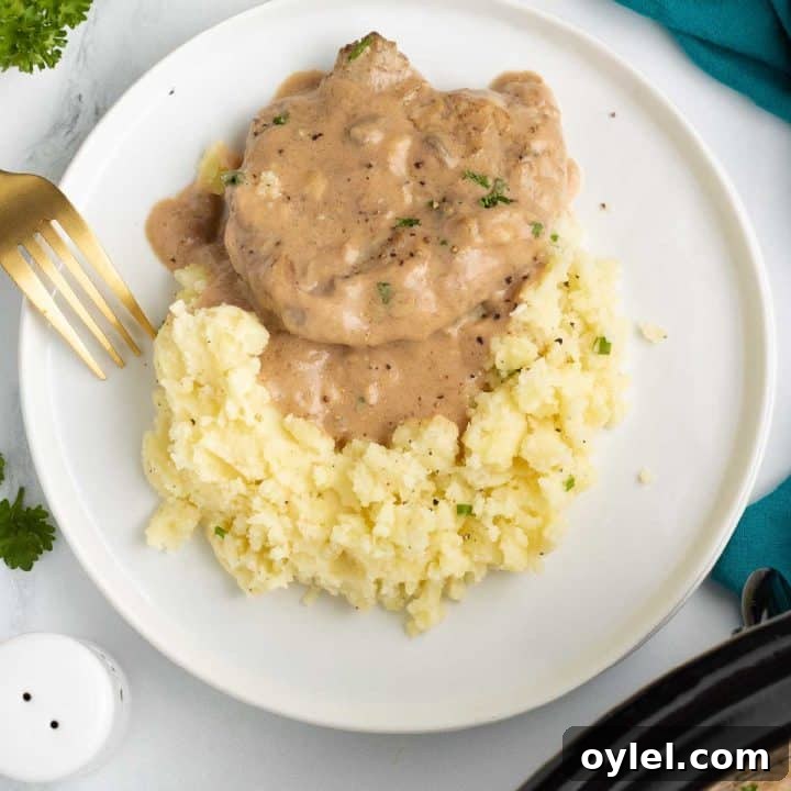 Cube steak with mushroom soup gravy served over mashed potatoes.