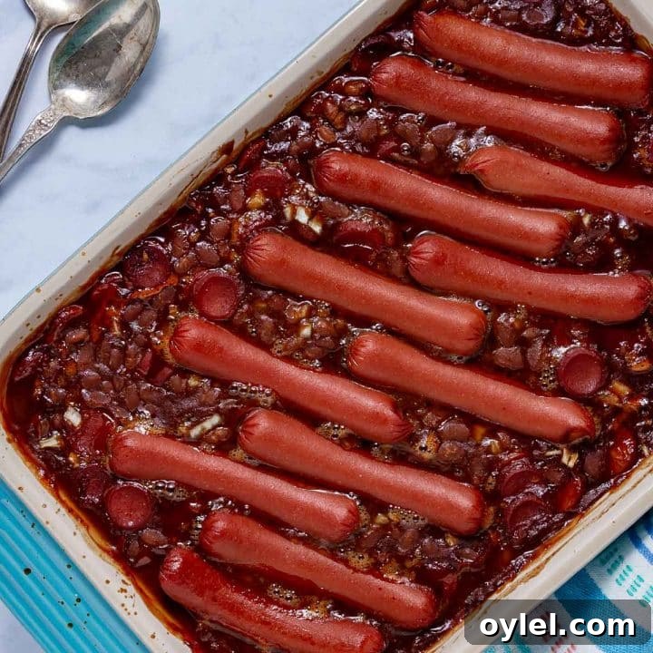 Baked franks and beans in a baking dish.