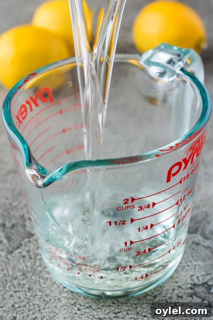 The finished syrup mixture pouring into a glass measuring cup.