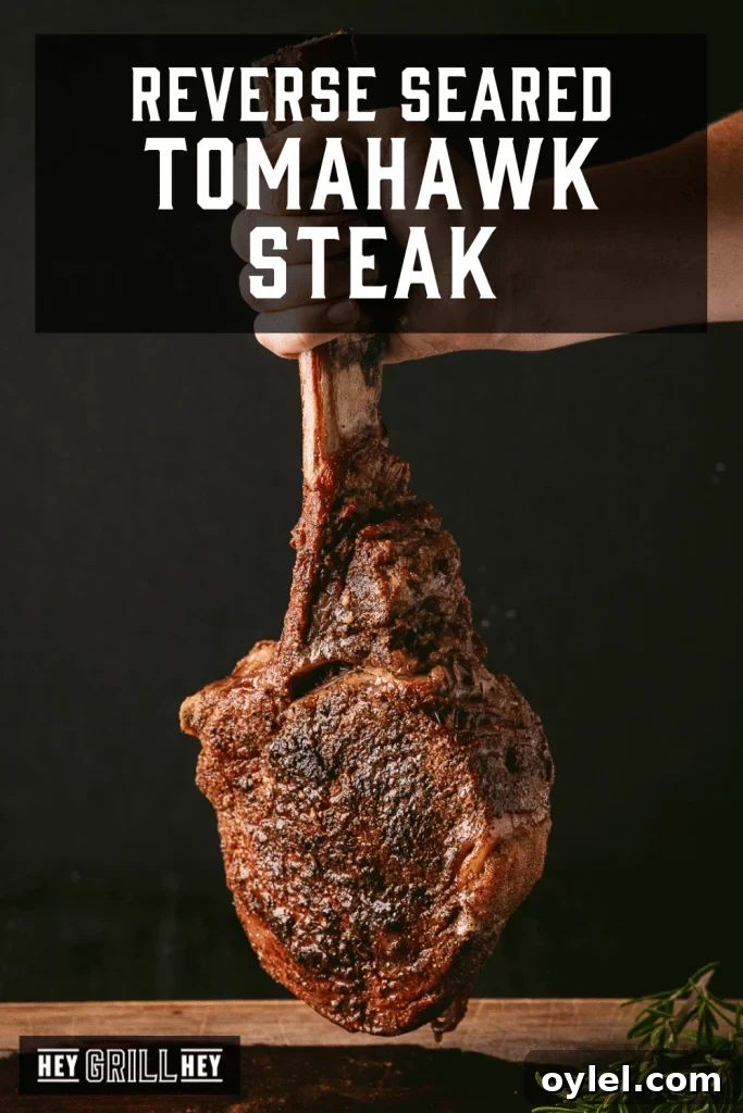 How to Reverse-Sear a Tomahawk Steak for Maximum Flavor 2 Grilled tomahawk steak being held by the bone with text overlay - Reverse Seared Tomahawk Steak.