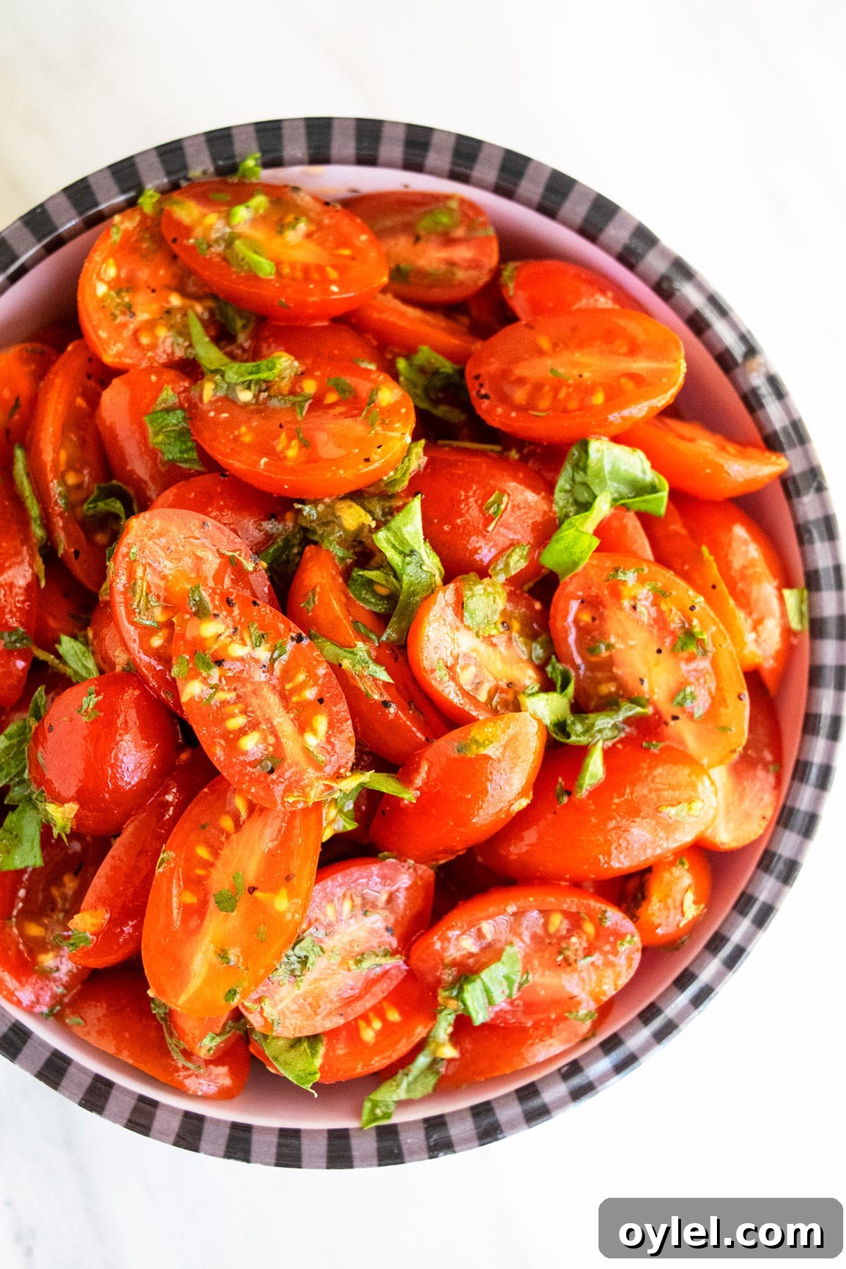 Easy homemade marinated tomatoes in black and white striped bowl- Overhead shot.