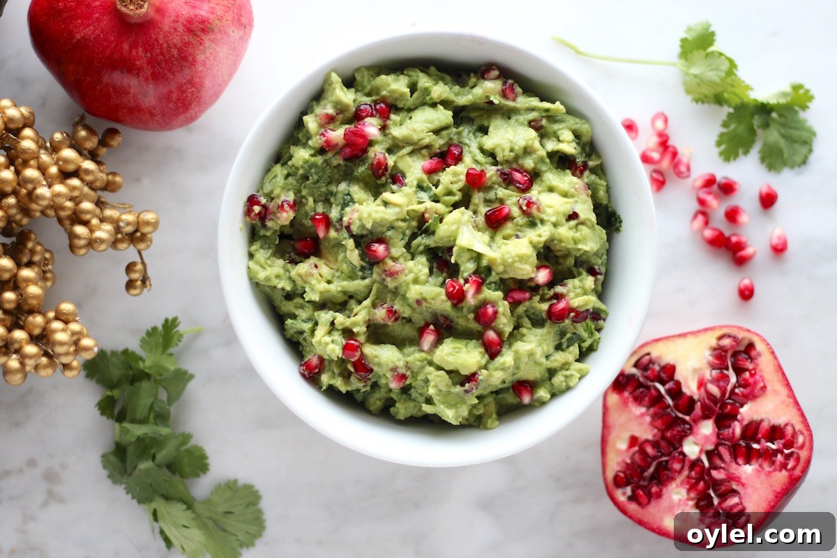 AIP Pomegranate Guacamole - a vegan, Paleo guac featuring colorful pomegranate seeds and orange juice, for a winter spin on a classic Mexican appetizer! | fedandfulfilled.com