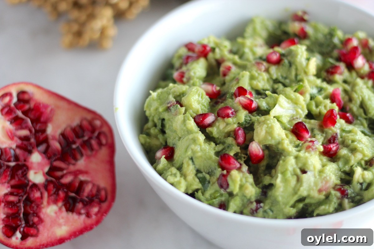 AIP Pomegranate Guacamole - a simple, easy, colorful appetizer that is perfect for holiday parties! This is delicious! | fedandfulfilled.com