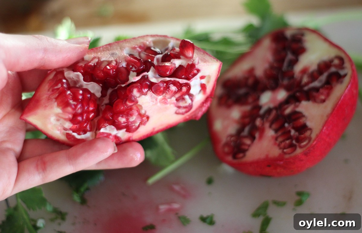 AIP Pomegranate Guacamole - a vegan, allergy-friendly appetizer that is perfect for your next party! Creamy avocados, crunchy pomegranate seeds, and sweet orange juice make this guac out of this world! | fedandfulfilled.com