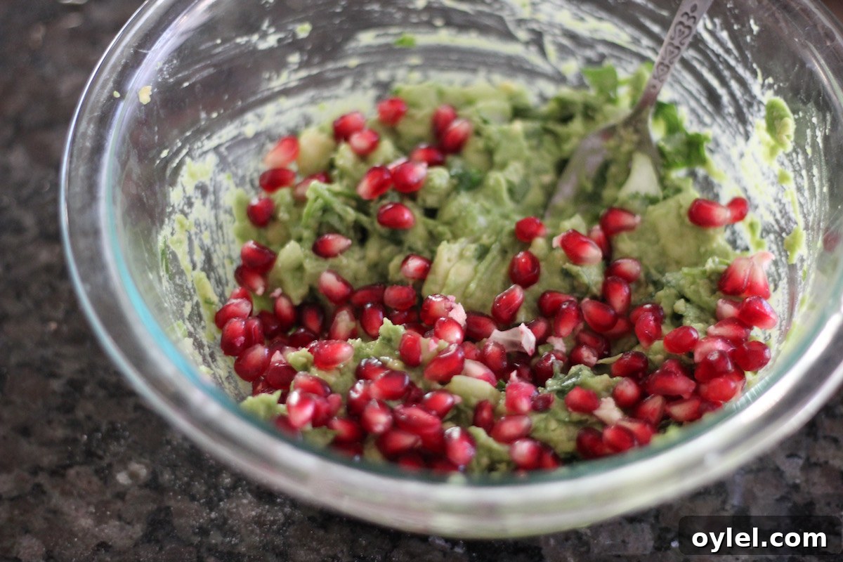 AIP Pomegranate Guacamole - a vegan, Paleo appetizer that is a beautiful dish for Christmas parties! Featuring sweet, tart, crunchy pomegranate seeds! | fedandfulfilled.com