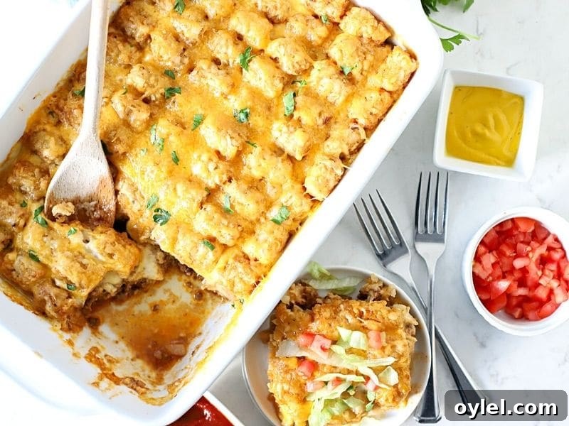 Weeknight Cheeseburger Tater Tot Casserole 7 cheeseburger casserole with a serving spoon