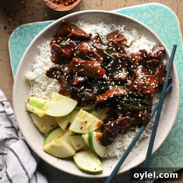 One-Pot Cajun Chicken Sausage and Rice 9 Mongolian beef served over rice with cucumber slices, green onions, and sesame seeds.