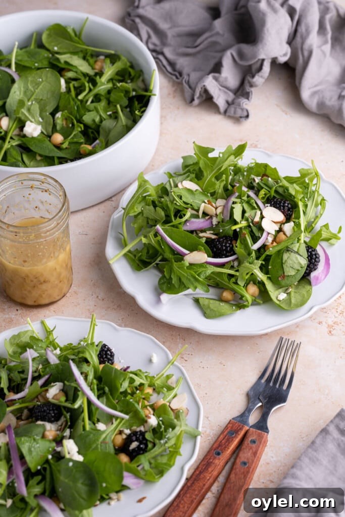 Spinach Arugula Salad with Honey Dijon Vinaigrette on salad plates