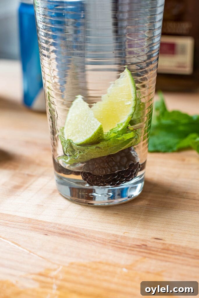 Blackberry Bourbon Smash Cocktail Recipe 4 Muddling blackberries and mint