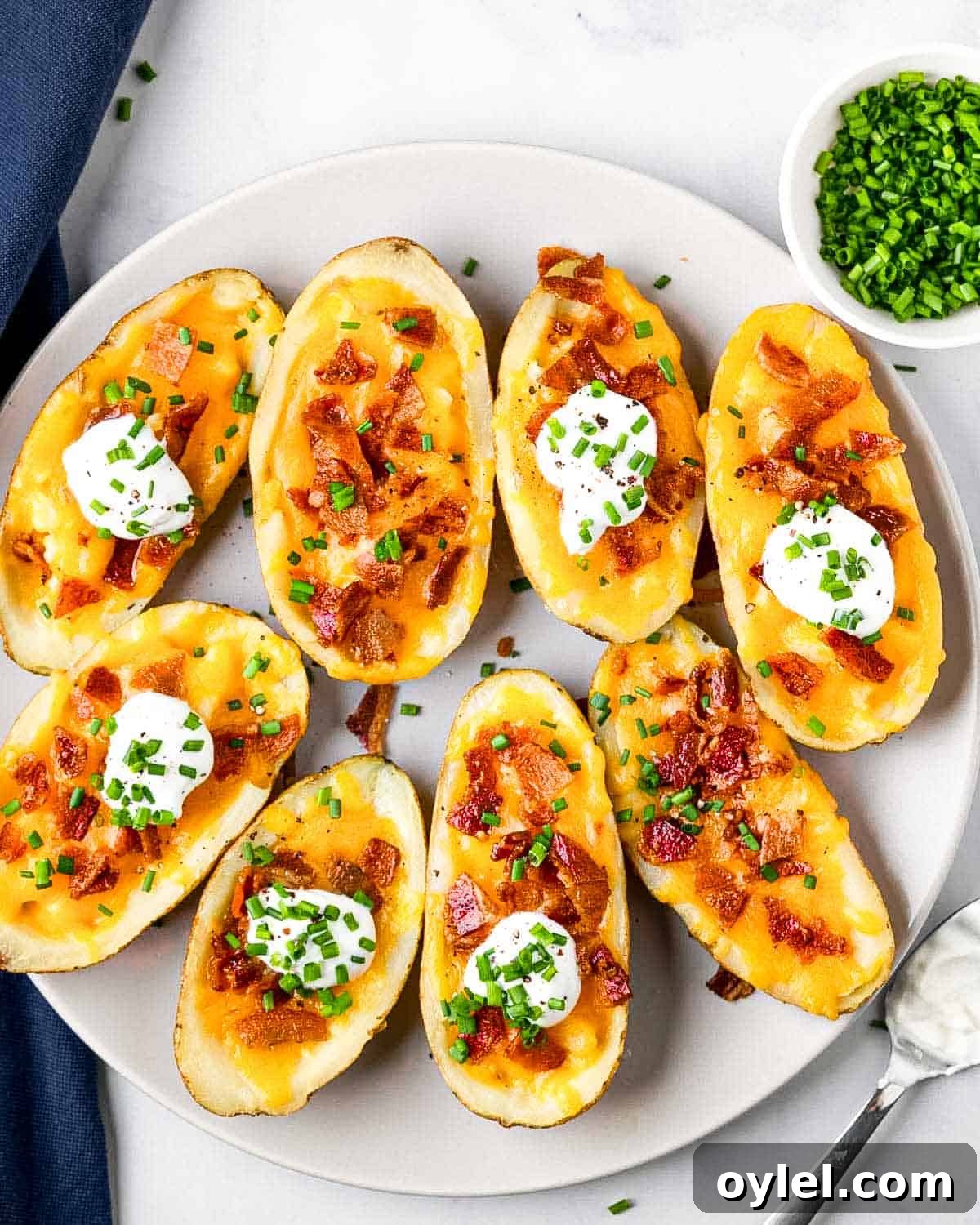 Crispy Air Fryer Potato Skins with Cheese and Bacon 10 plate of 8 air fryer potato skins and toppings.