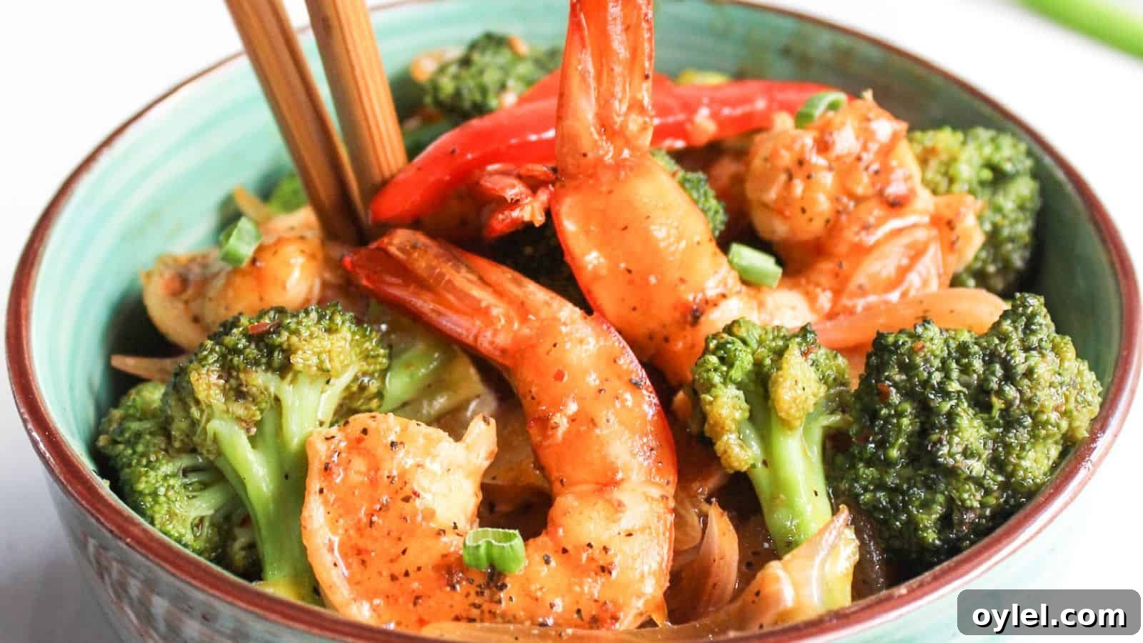 13 Asian Recipes You Won't Believe Are This Simple 12 Bowl of stir-fried shrimp and broccoli with chopsticks.