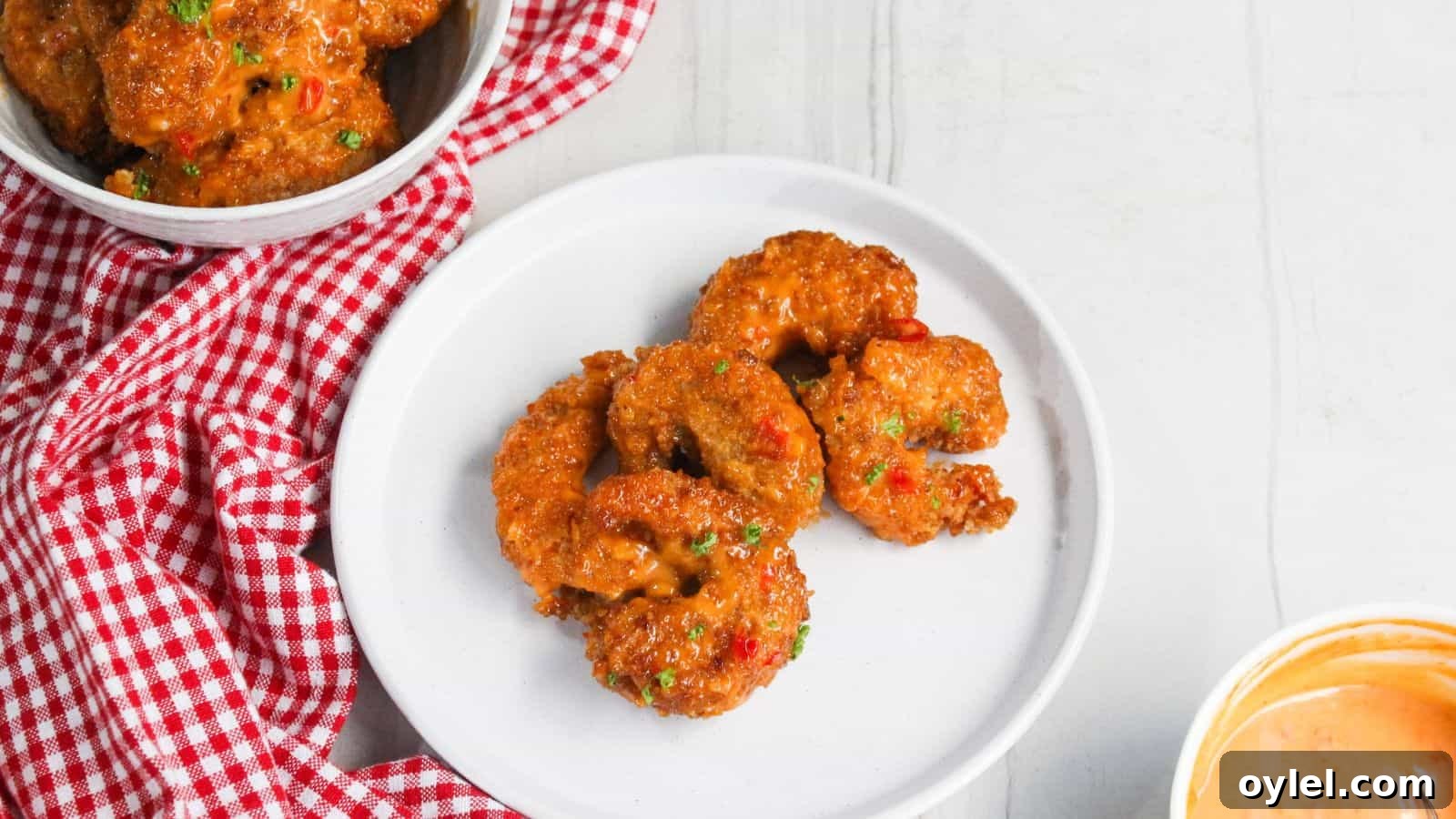 13 Asian Recipes You Won't Believe Are This Simple 8 Fried shrimp on a plate next to a bowl of sauce.