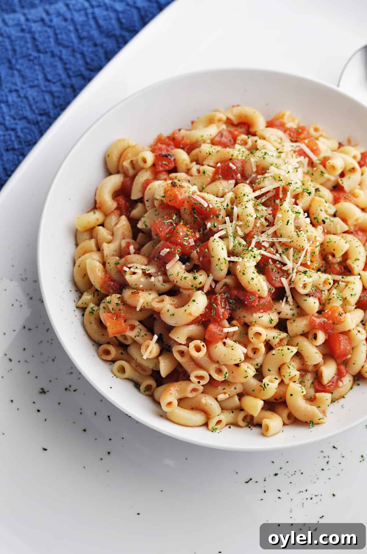 Macaroni & tomatoes recipe in white bowl