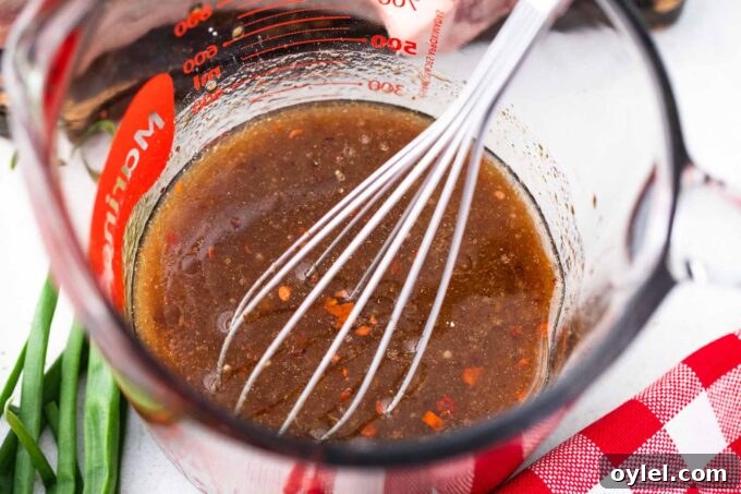 Asian style marinade for steak in a large measuring cup.