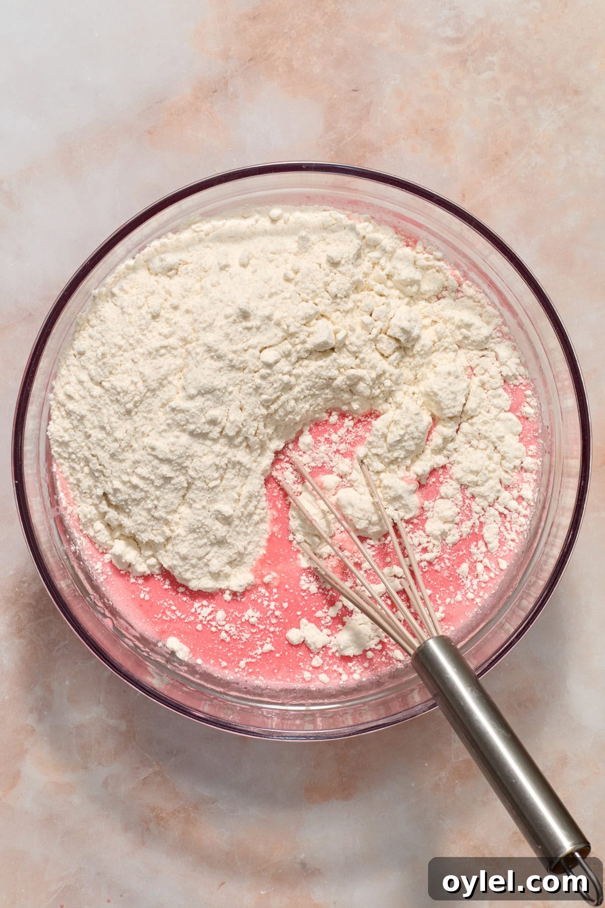 Strawberry Crunch Cupcakes Recipe with Crumble Topping 5 Cake mix added to bowl with whisk.