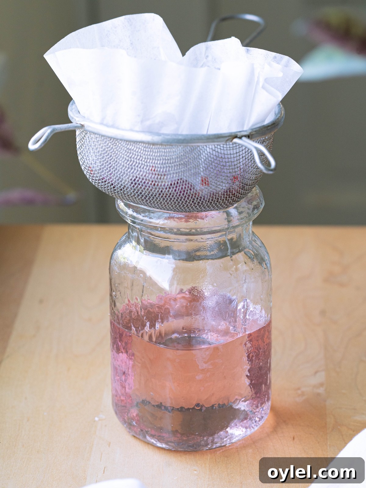 How to Make Rose Simple Syrup for Cocktails and Desserts 6 A setup for straining infused simple syrup