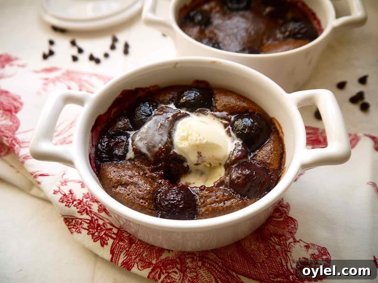 Freshly baked Almond Flour Chocolate Cherry Lava Cakes with ice-cream melting on it.