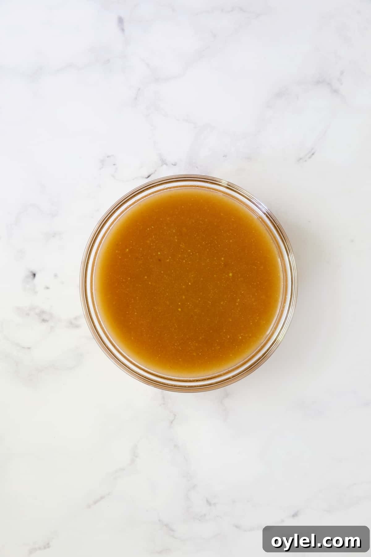 Sauce for cabbage in glass bowl before being cooked.