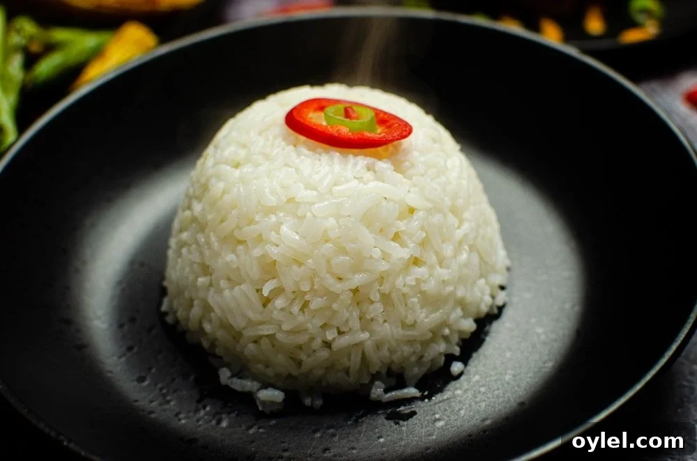Authentic Jasmine Sticky Rice Recipe from Thailand 2 Jasmine Sticky Rice served in a black bowl with red chilli on top