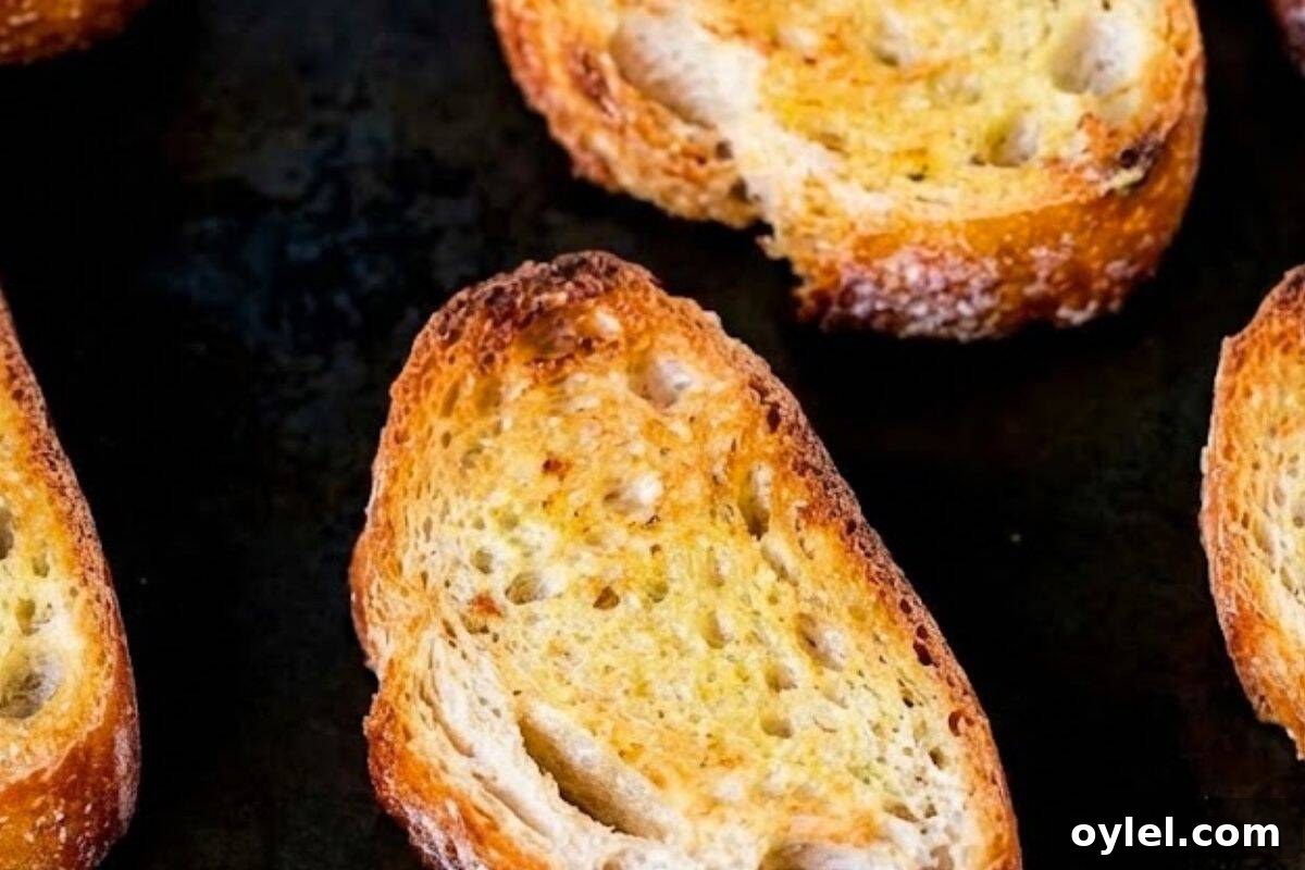 Preheat your grill or broiler to medium high, arrange the bread slices on a lightly greased tray, and toast until golden and crisp.