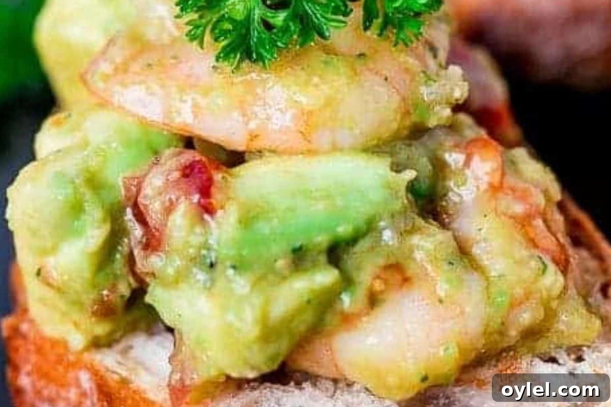 Fold the warm prawns through the avocado mixture, then spoon everything generously over the toasted bread.
