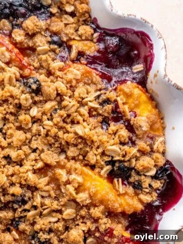 Blueberry and peach crisp in a pie dish.