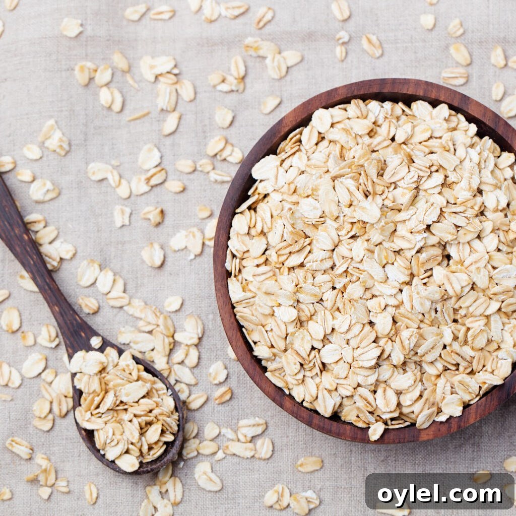 Rolled oats on a wooden spoon and bowl
