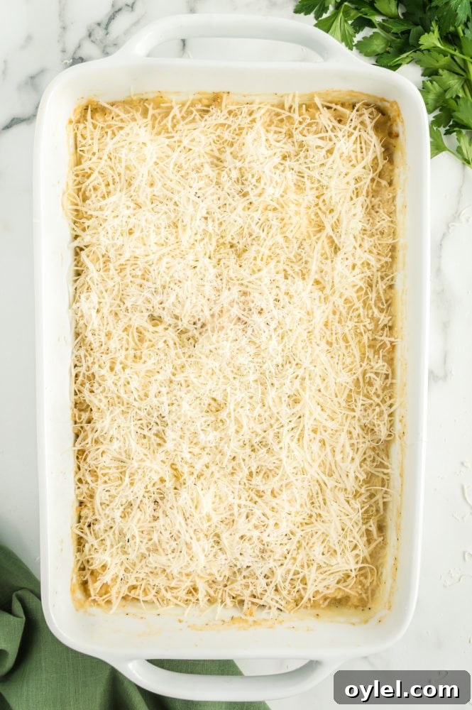 A chicken rice casserole baked in a white casserole dish