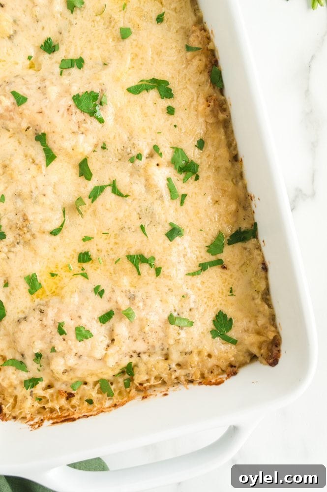 Cheesy chicken and rice casserole baked in a white dish